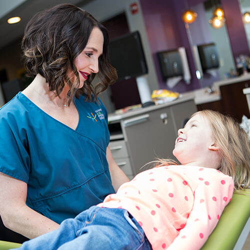 Dr. Juntgen treating a young patient at her pediatric dentist office in Carmel. IN