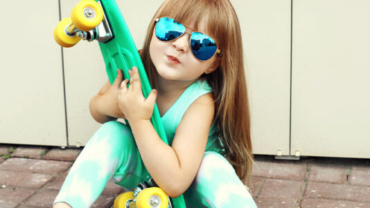 Young girl with sunglasses and penny board