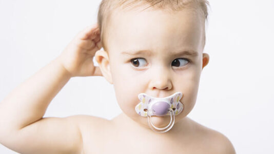 Baby with pacifier in mouth