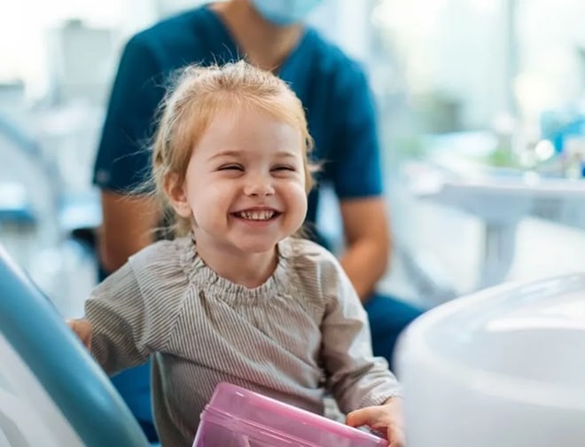 toddler smiling and showing her teeth