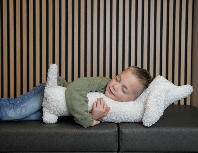 Boy sleeping in dentist waiting room