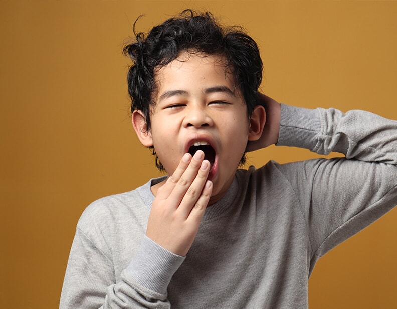 Boy yawning